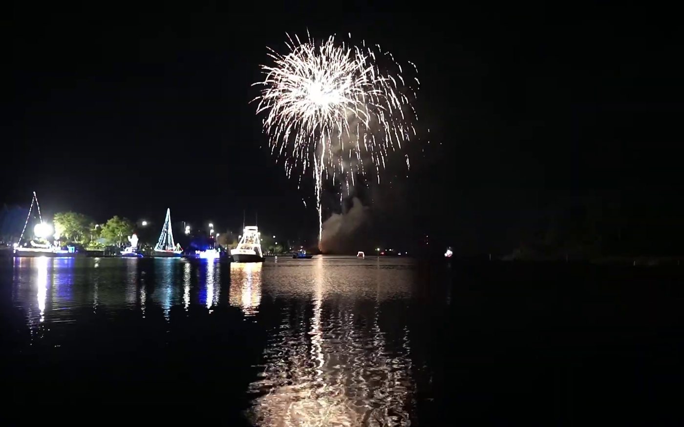 Fireworks over the lighted boat parade at Christmas by the River.