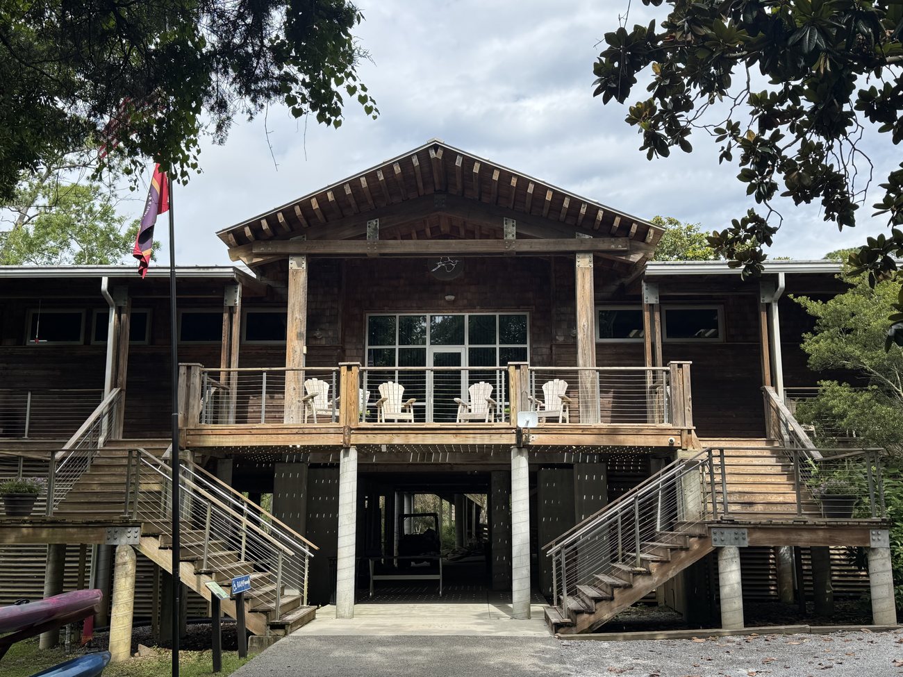 The Pascagoula River Audubon Center, an elevated wooden building with a wide deck among live oaks in Moss Point.
