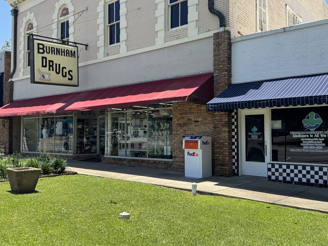 Burnham Drugs on Main Street, a historic storefront with red awnings.