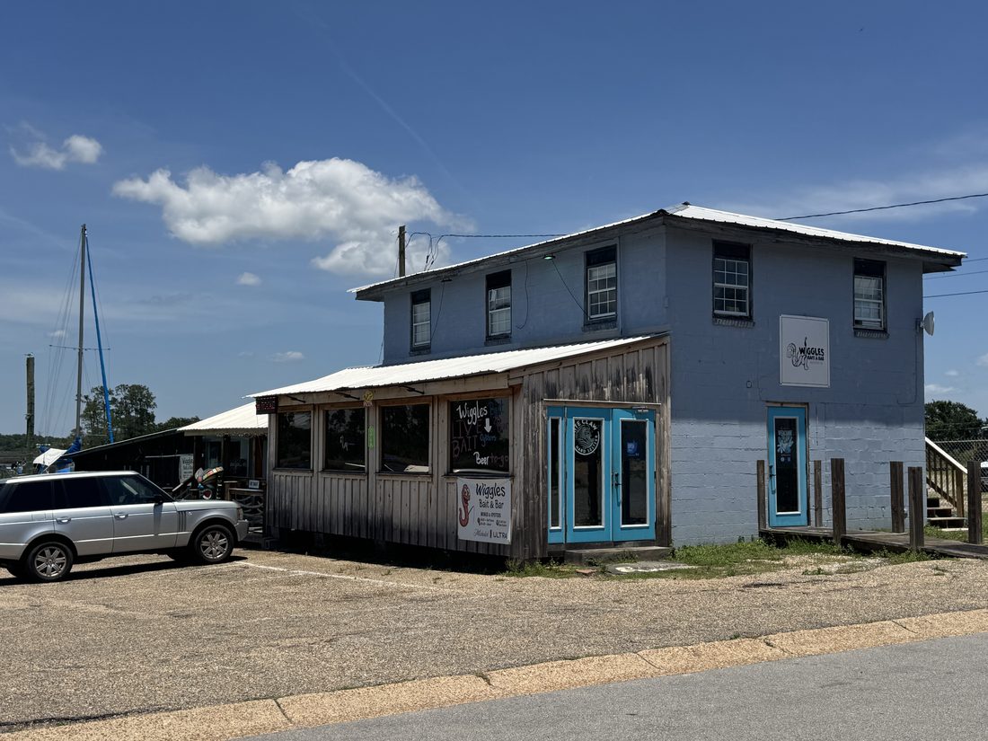 Wiggles Bait and Bar, a rustic waterfront building beside the marina.