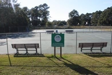 Lighted tennis courts and walking track at a Moss Point park.