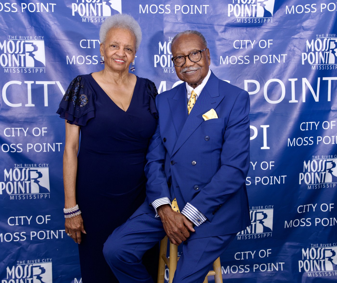 Mayor Billy Knight Sr. and First Lady Lois Knight seated in front of a City of Moss Point backdrop.