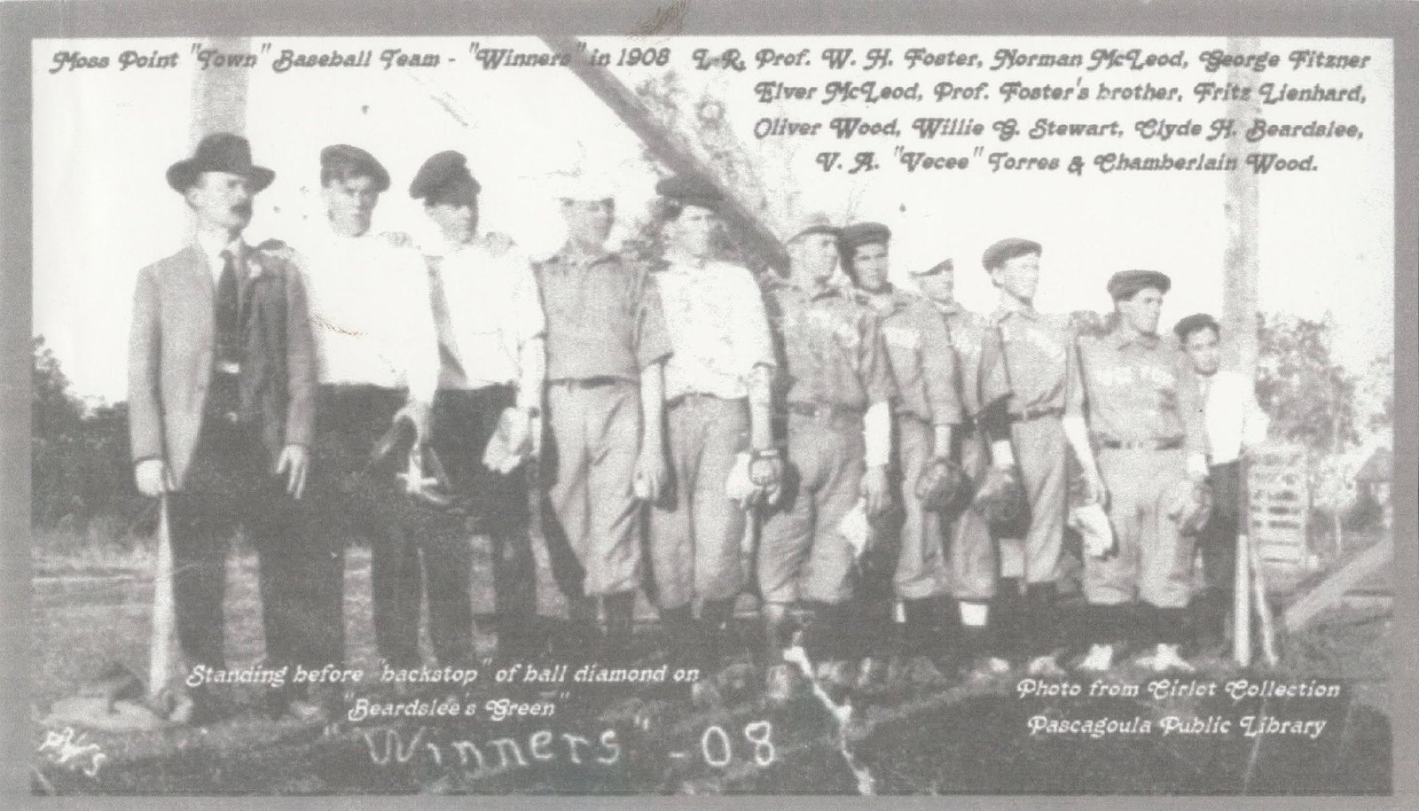 The Moss Point town baseball team of 1908 stands in a row before the backstop of a ball field, several in striped uniforms, names handwritten across the photograph.