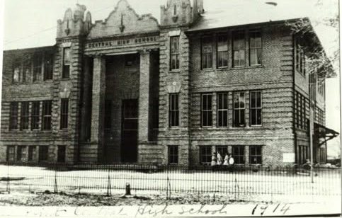 An ornate three story brick Central High School building behind an iron fence in Moss Point in 1914.