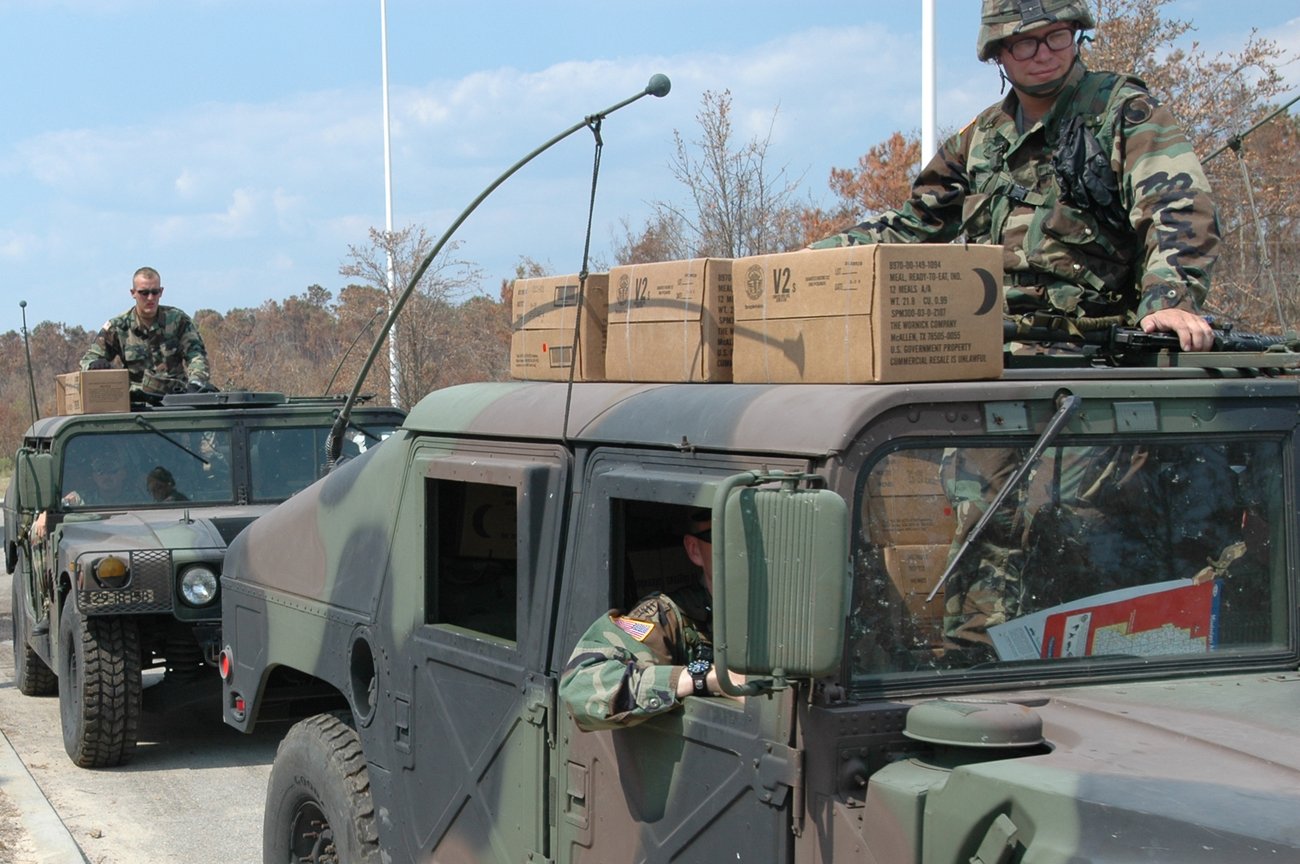 Maryland National Guard soldiers on a Humvee loaded with relief supplies arrive in Moss Point after Hurricane Katrina in September 2005.