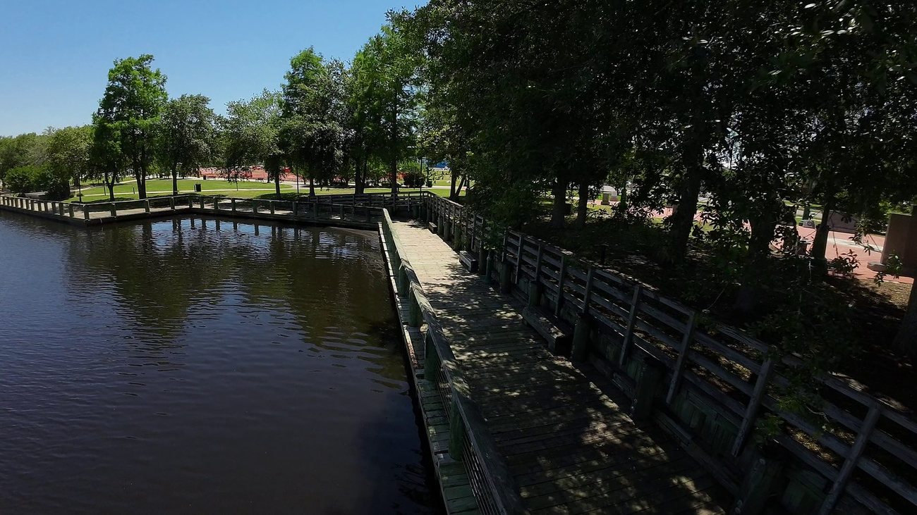 A wooden boardwalk reaching out over the Escatawpa River at the downtown Moss Point riverfront.