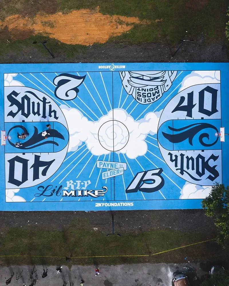 An aerial view of the rebuilt basketball court with the words South 40 painted into its blue and white mural.