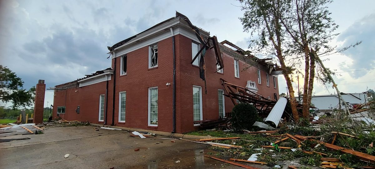 The Merchants and Marine Bank in downtown Moss Point with its roof torn off and debris across the parking lot after the June 2023 tornado.