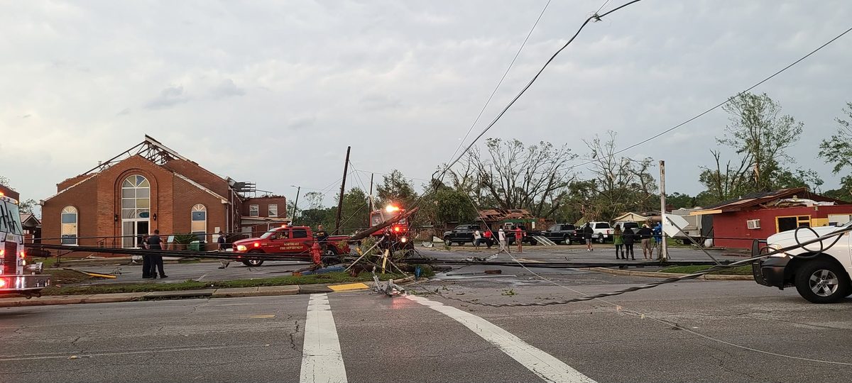 First Missionary Baptist Church in Moss Point stripped to its rafters, with snapped utility poles and downed power lines across the street.