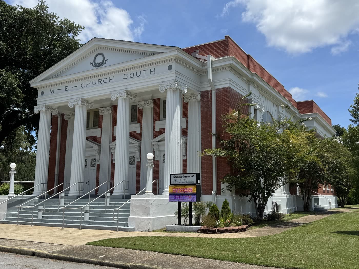 Dantzler Memorial, a red brick church with a white columned portico reading M E Church South across its pediment.
