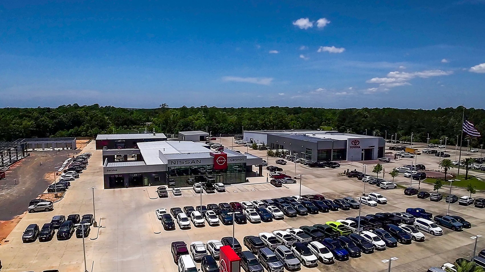 Aerial drone view of the Nissan and Toyota dealerships, open and operating