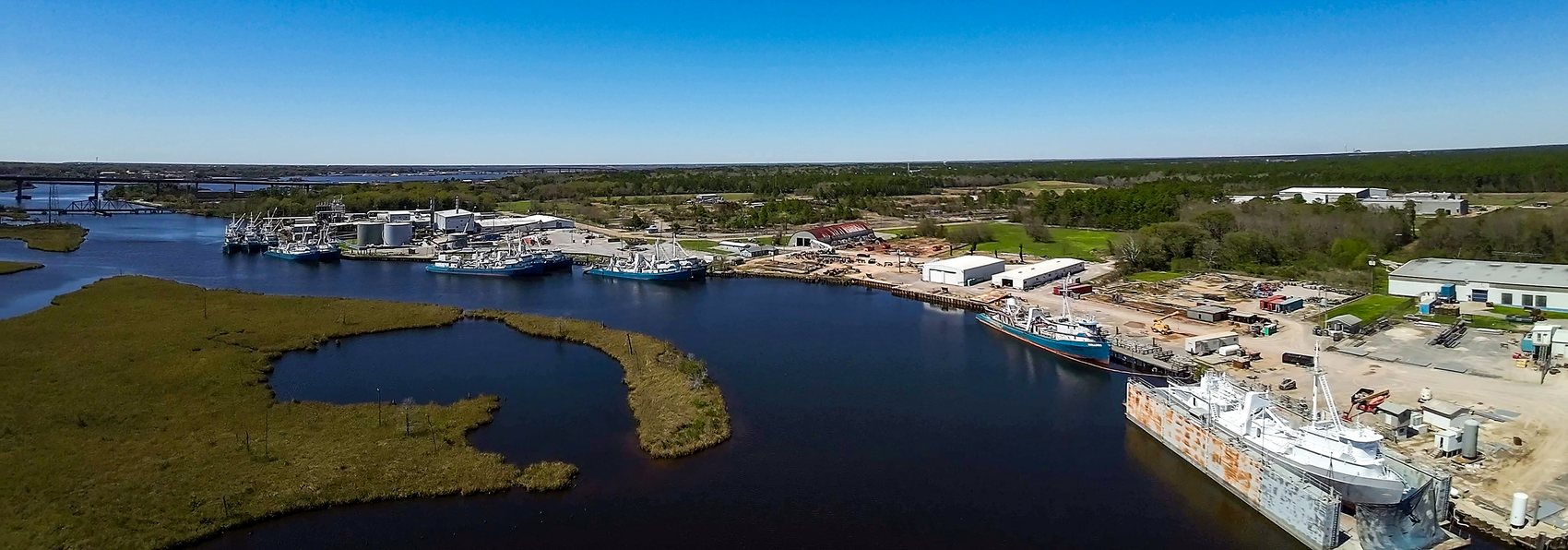 Aerial view of the Omega Protein menhaden plant, the fishing fleet, and the shipyard on the Escatawpa River near the Hwy 63 bridge in Moss Point
