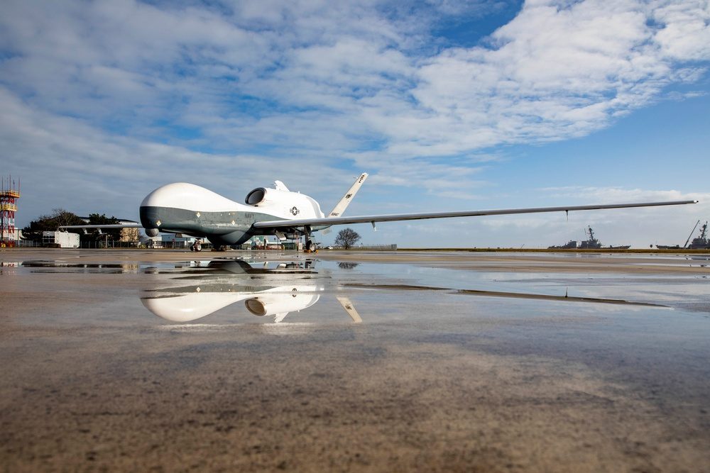 An MQ-4C Triton unmanned aircraft on a U.S. Navy flight line; its fuselage is built in Moss Point