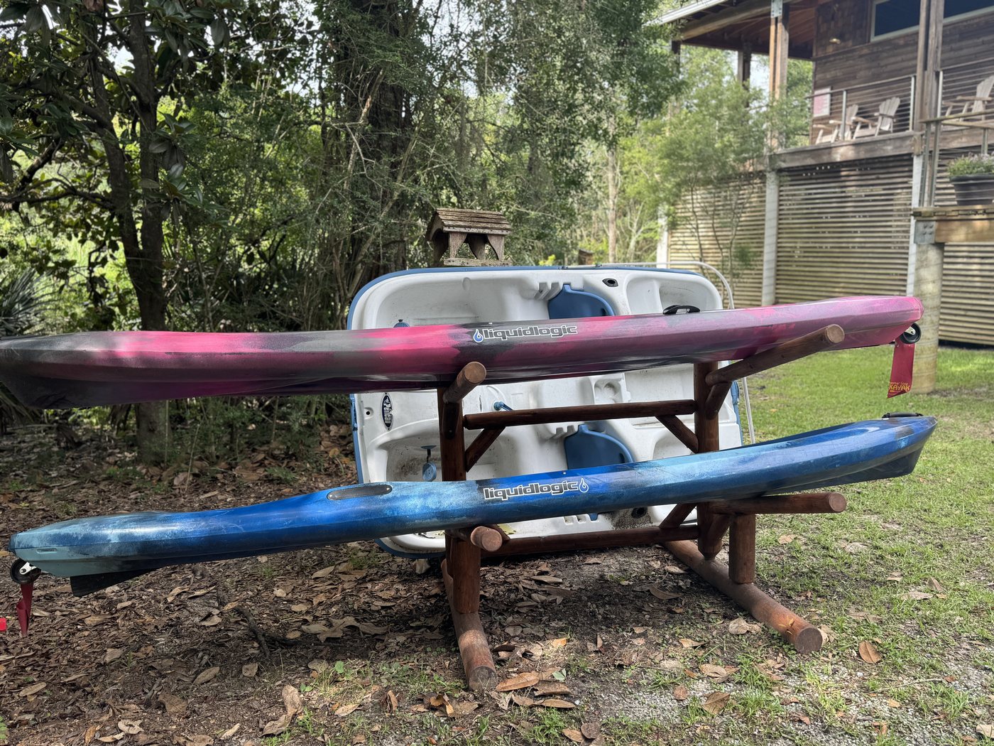 Kayaks on a rack at the Pascagoula River Audubon Center, ready to launch from the property.