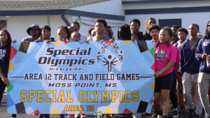 Students carry the Special Olympics Mississippi Area 12 Track and Field Games Moss Point banner during the processional at Jerry Alexander Stadium