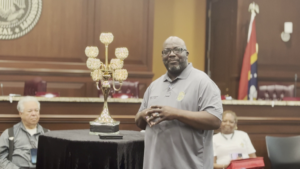 Chief Dennis Stevenson speaking during the Moss Point Police Department Meet and Greet at City Hall with community members seated behind him