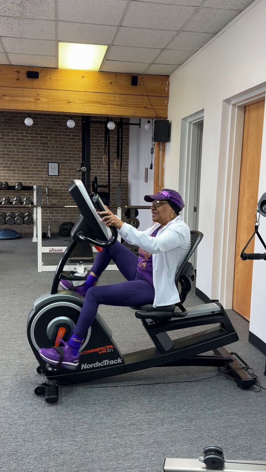 A member working out on a cycling bike at the River City Fitness Center