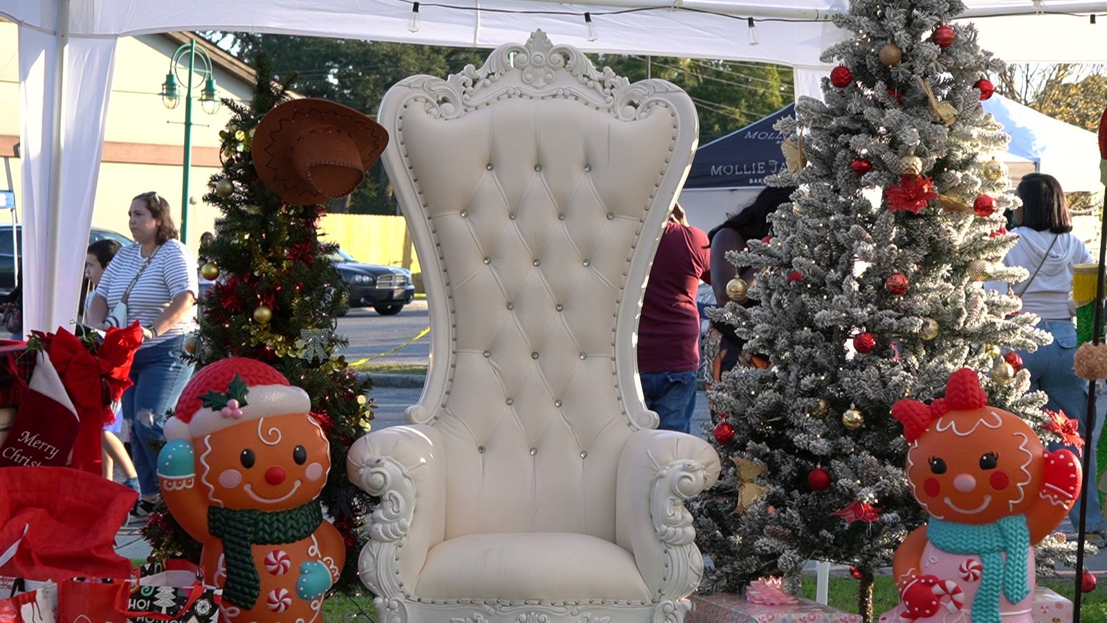 Sell at Christmas by the River: Santa's white chair waits between decorated Christmas trees at last year's festival on the riverfront